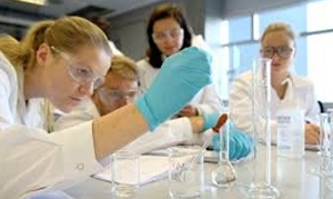 group of students performing an experiment in a lab