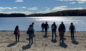 students outside near body of water
