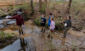 student outside in stream area