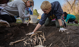 students outside at a paleontology dig site