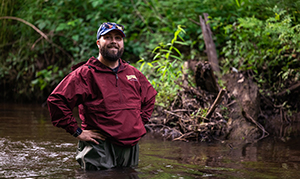 student outside near stream
