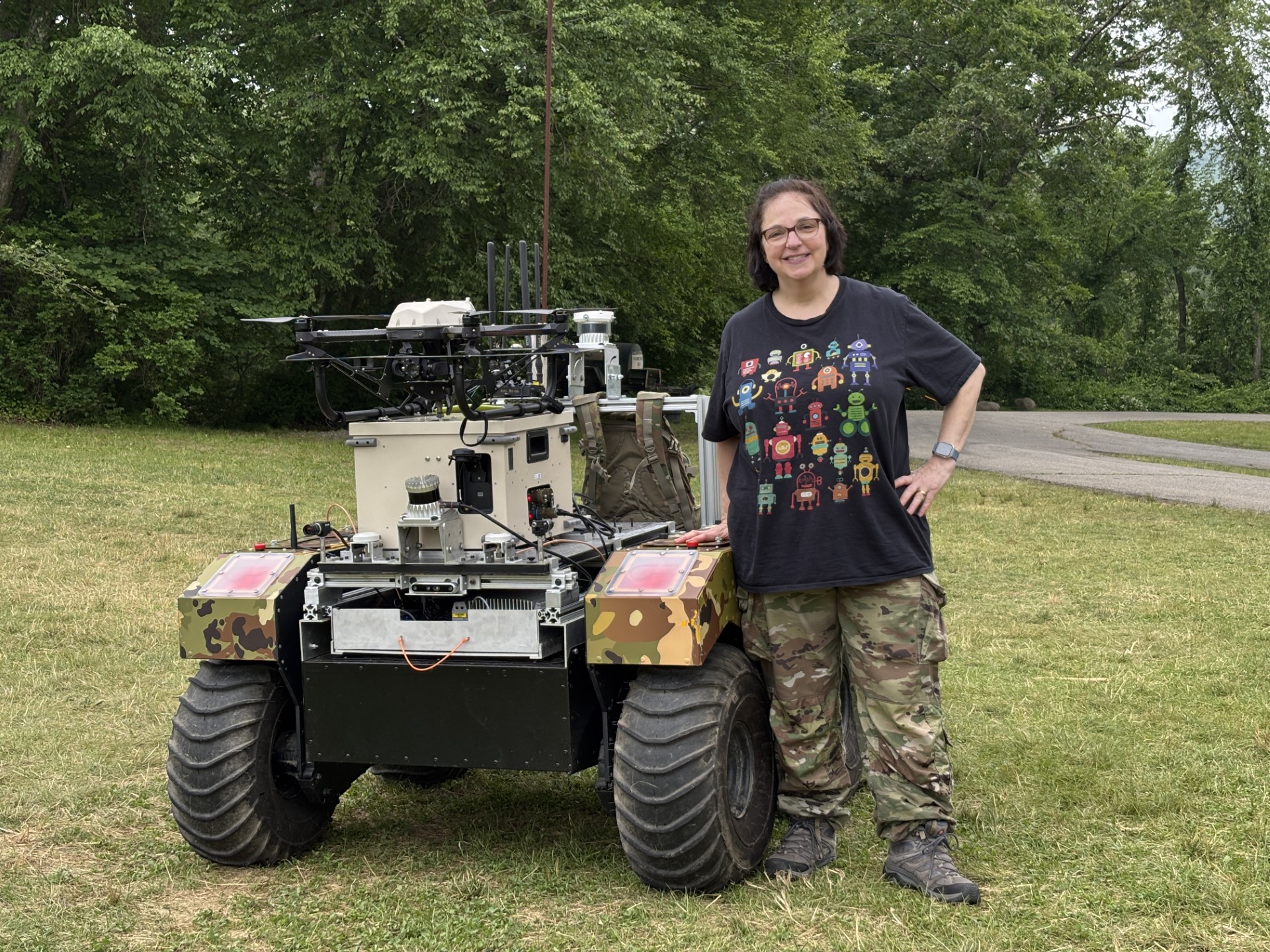 Dr. Kay standing next to a robot.