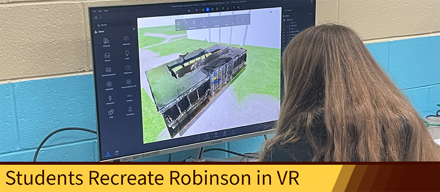 An image of Mary Moor, working on a computer, examining a VR model of Robinson.