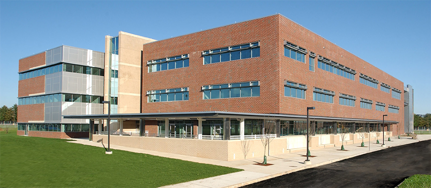 A photograph of James Hall taken on a cloudless, sunny day. The photo was taken on its north side, by the daycare. There is no garden, as this photo predates its establishment.