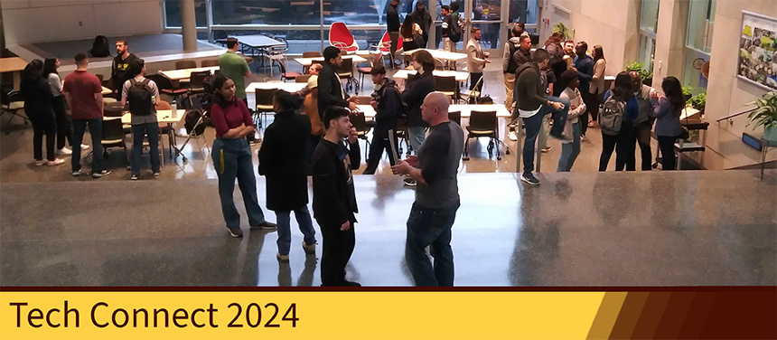 A group of students and alumni broken up into small discussion groups. They are standing in Rowan Hall 117. There is a yellow banner on the bottom of the image that reads, "Tech Connect 2024." The banner fades into a brown gradient on your right.