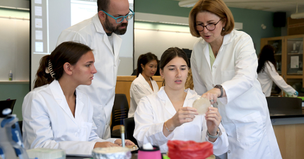 Professor Marina Bogush (right) and lab technician Ent Natale assist Kylie Oliver (second from right) and Paige Baldwin in a new honors biology course to discover unknown bacteriophages.