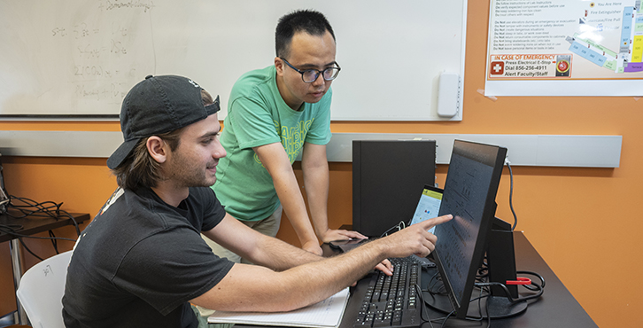 two students working together on a computer