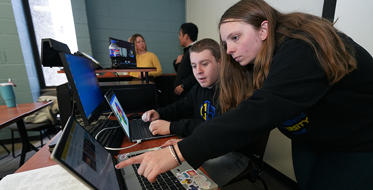 two students working together on computer