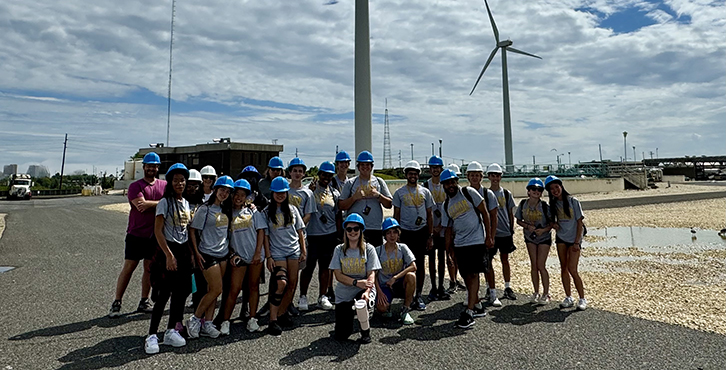 large group photo in front of windmills