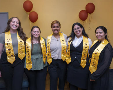 students in cap and gown at graduation