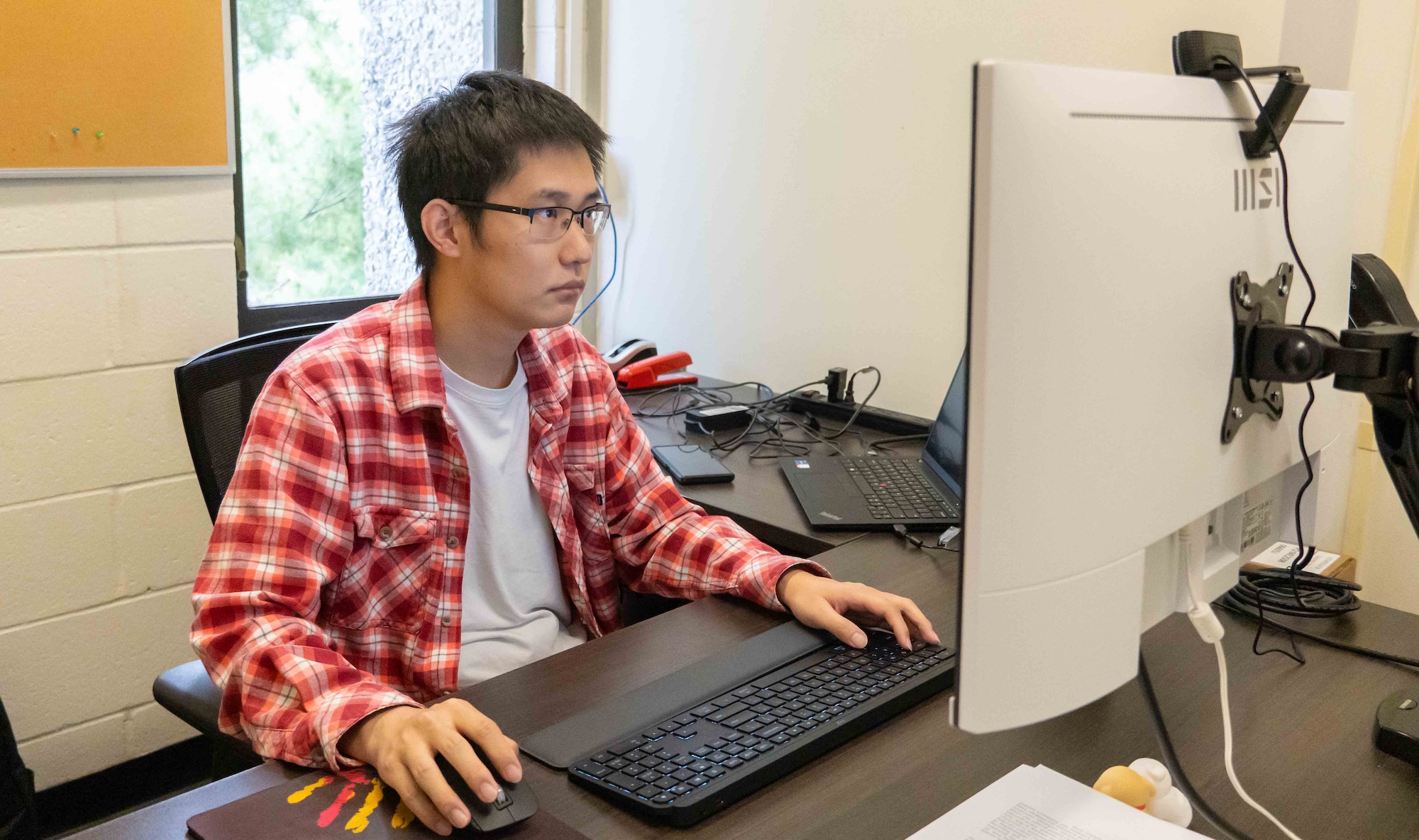 Dr. Lou working at his desk.