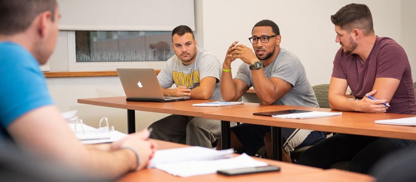 Four students in a classroom